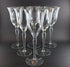 Set of six clear wine glasses on a dark background