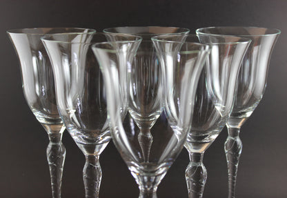 Set of clear glass wine glasses on a dark background