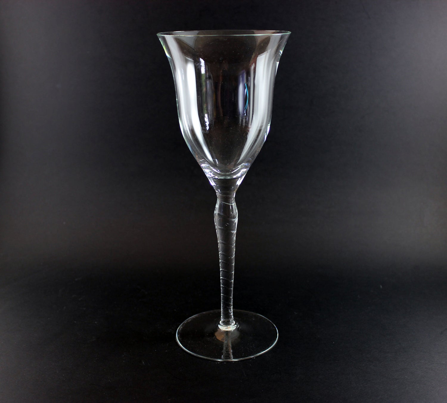 Clear glass wine glass on a black background