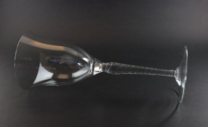 Clear glass wine glass on a black background