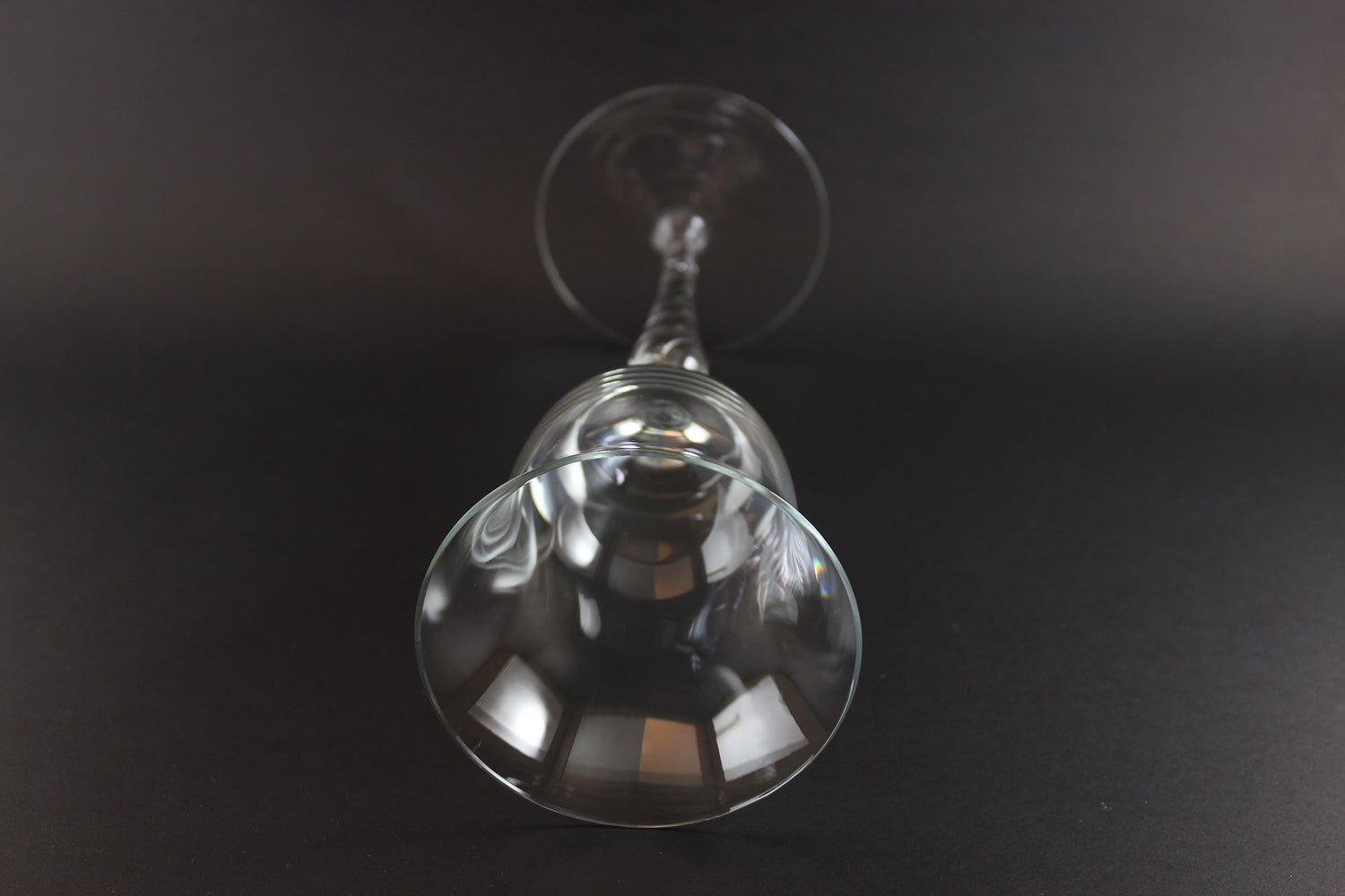 Clear glass wine glass on a black background