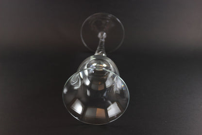 Clear glass wine glass on a black background
