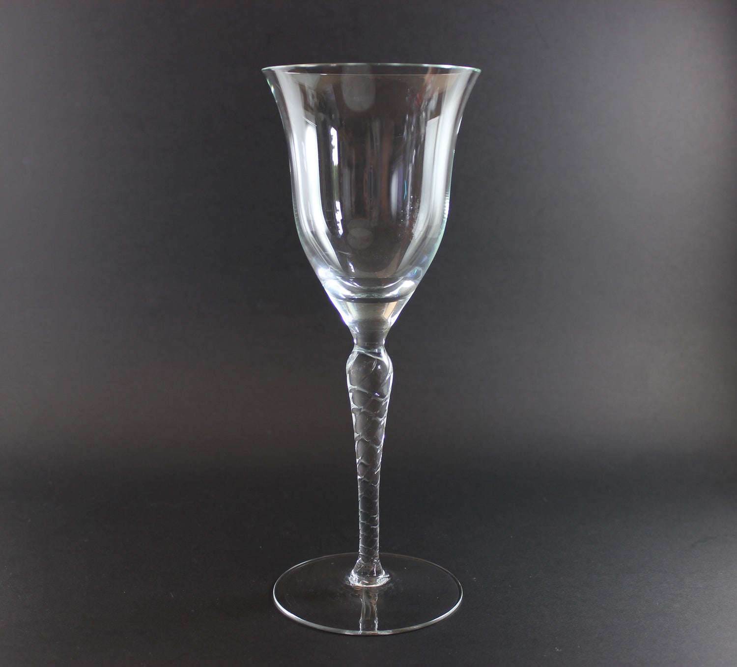 Clear glass wine glass on a black background