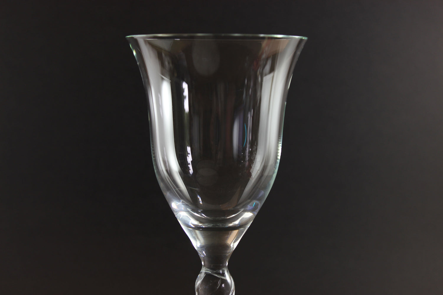 Clear glass goblet on a black background