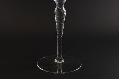 Clear glass wine glass on a black background