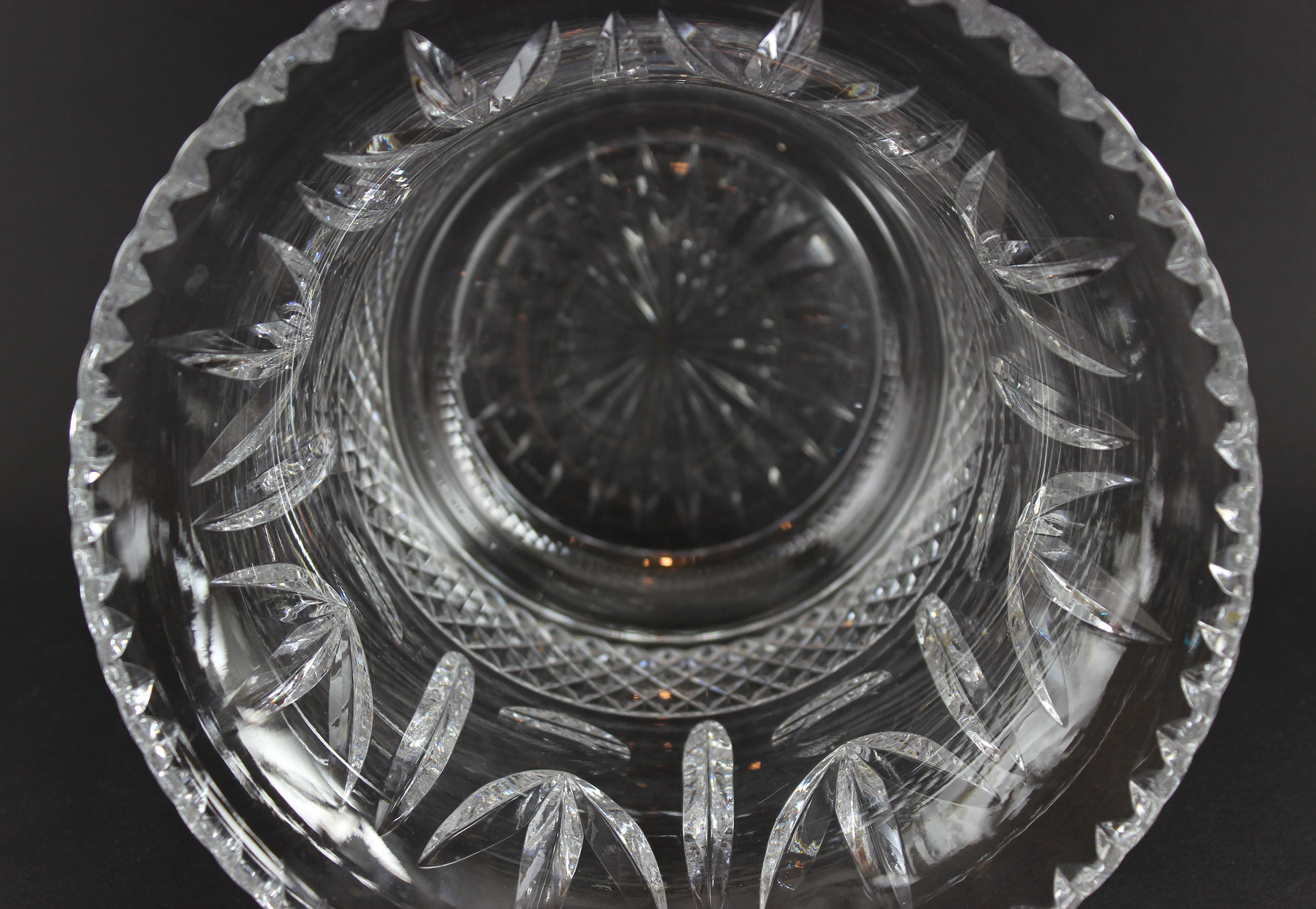 Large Crystal vase or bowl with intricate cut patterns on a black background