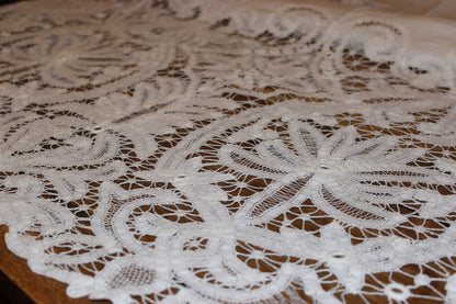 Close-up of intricate lace fabric on a wooden surface