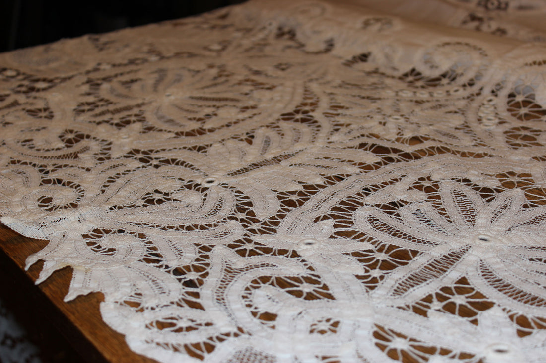 Close-up of intricate lace fabric on a wooden surface