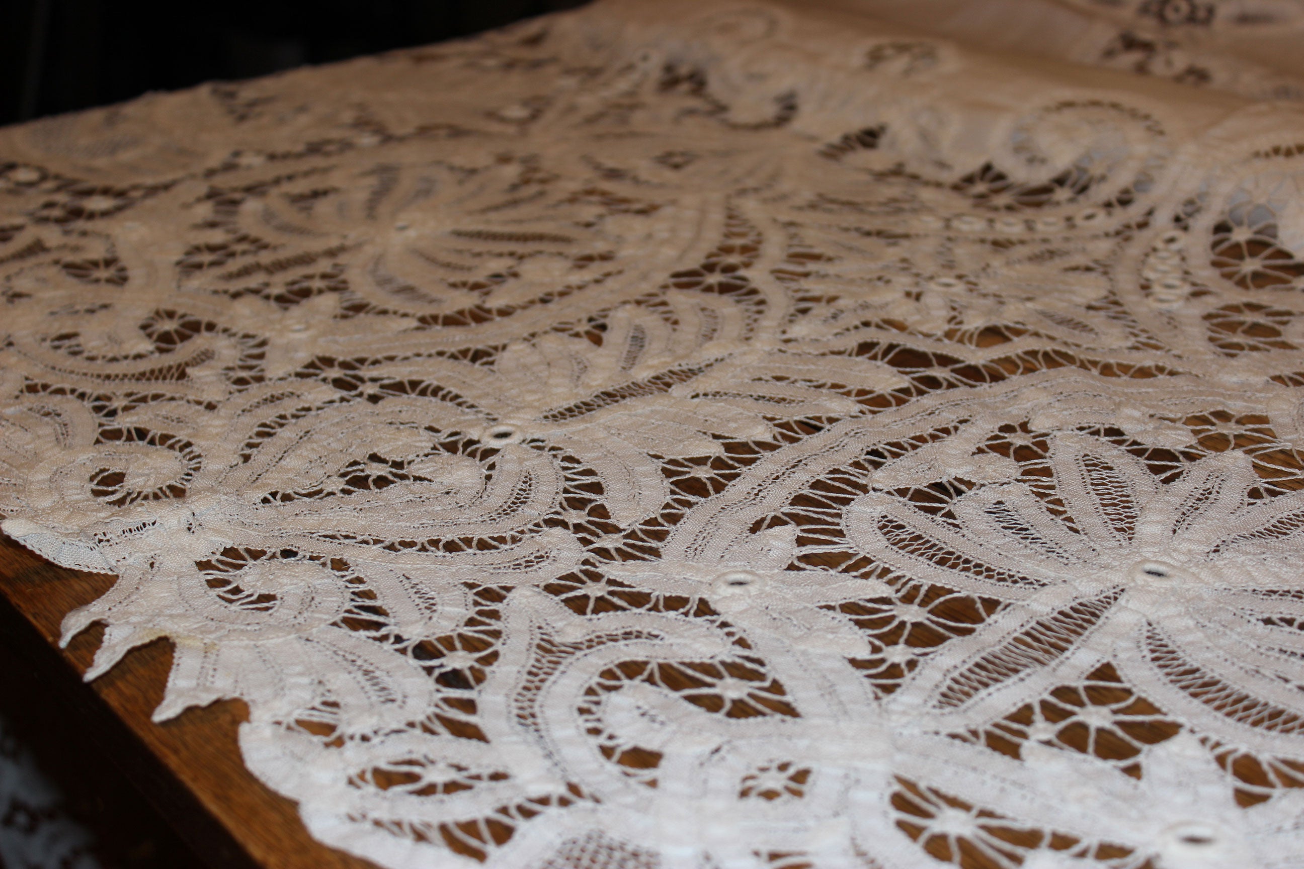 Close-up of intricate lace fabric on a wooden surface