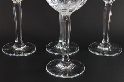 Three clear glass wine glasses on a black background
