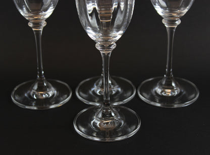 Four Mikasa Stephanie Pattern clear champagne flutes on a black background