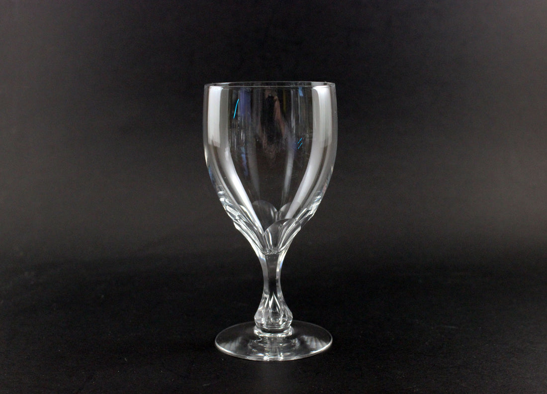 Clear glass wine glass on a black background