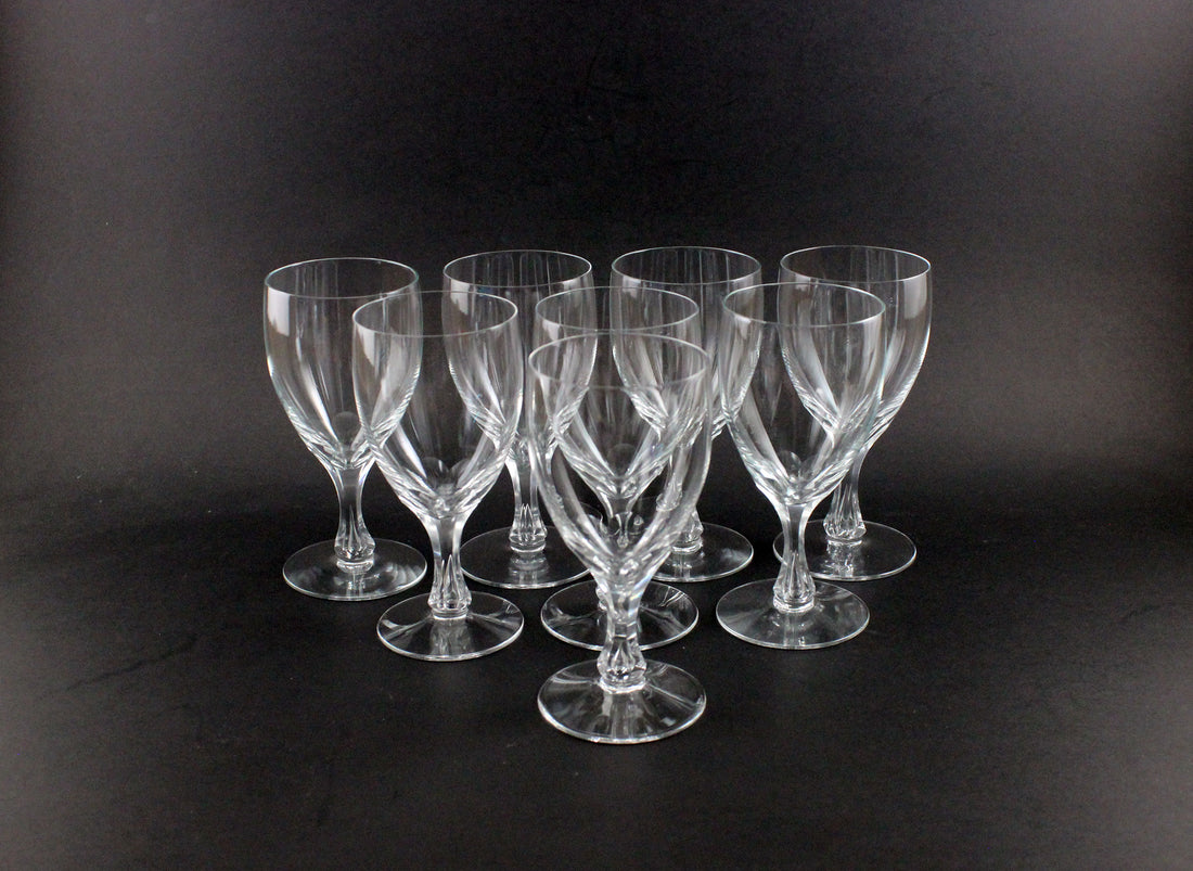 Set of clear glass wine glasses on a black background
