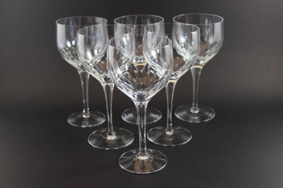 Set of six clear Orrefors Prelude wine glasses on a dark background