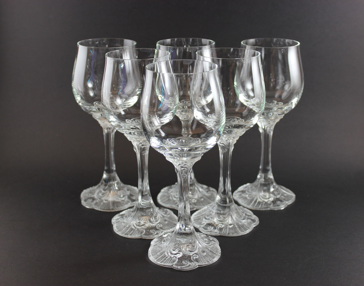 Set of clear wine glasses on a black background