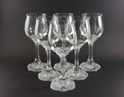 Set of clear wine glasses on a black background