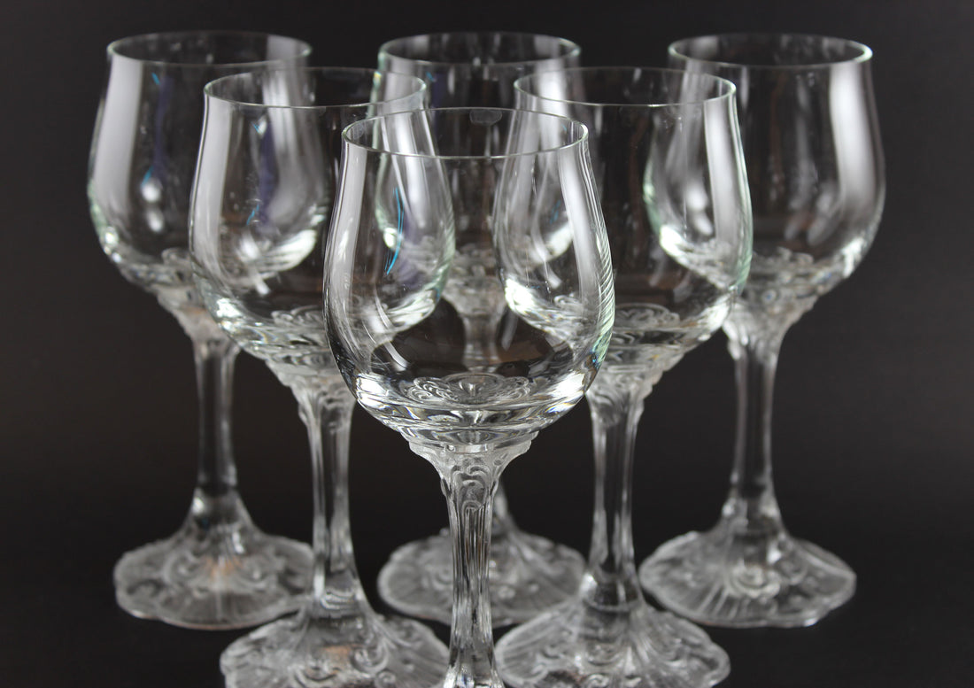 Set of clear glass wine glasses on a black background