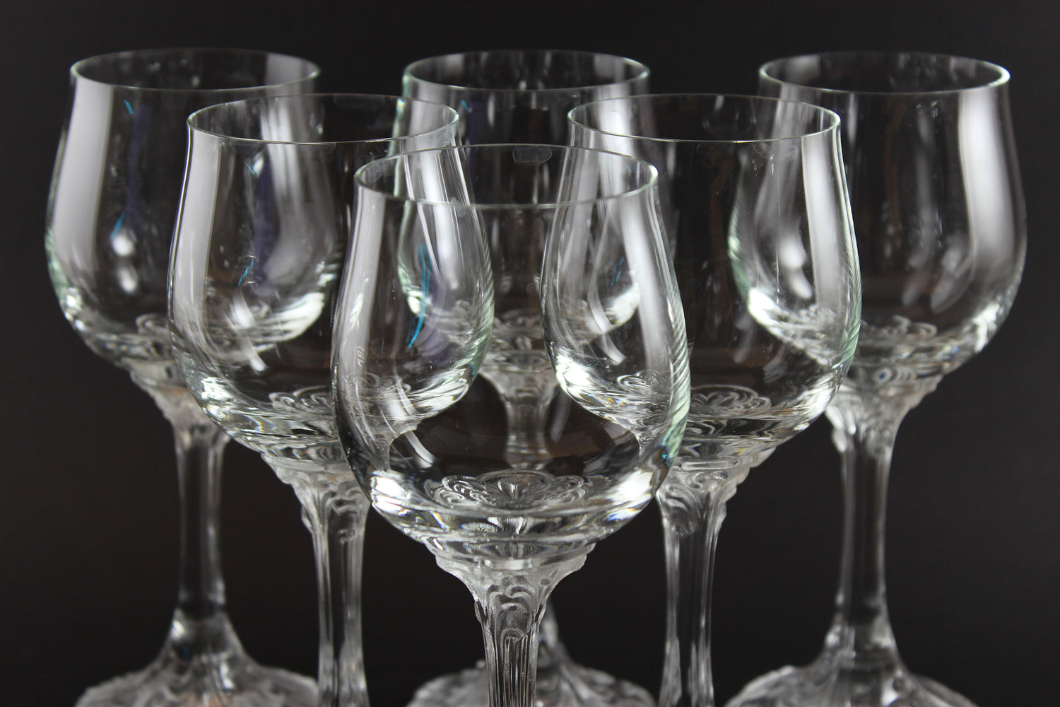 Set of clear wine glasses on a black background