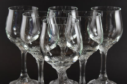 Set of clear wine glasses on a black background