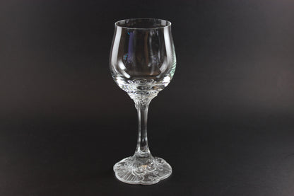 Clear glass wine glass on a black background