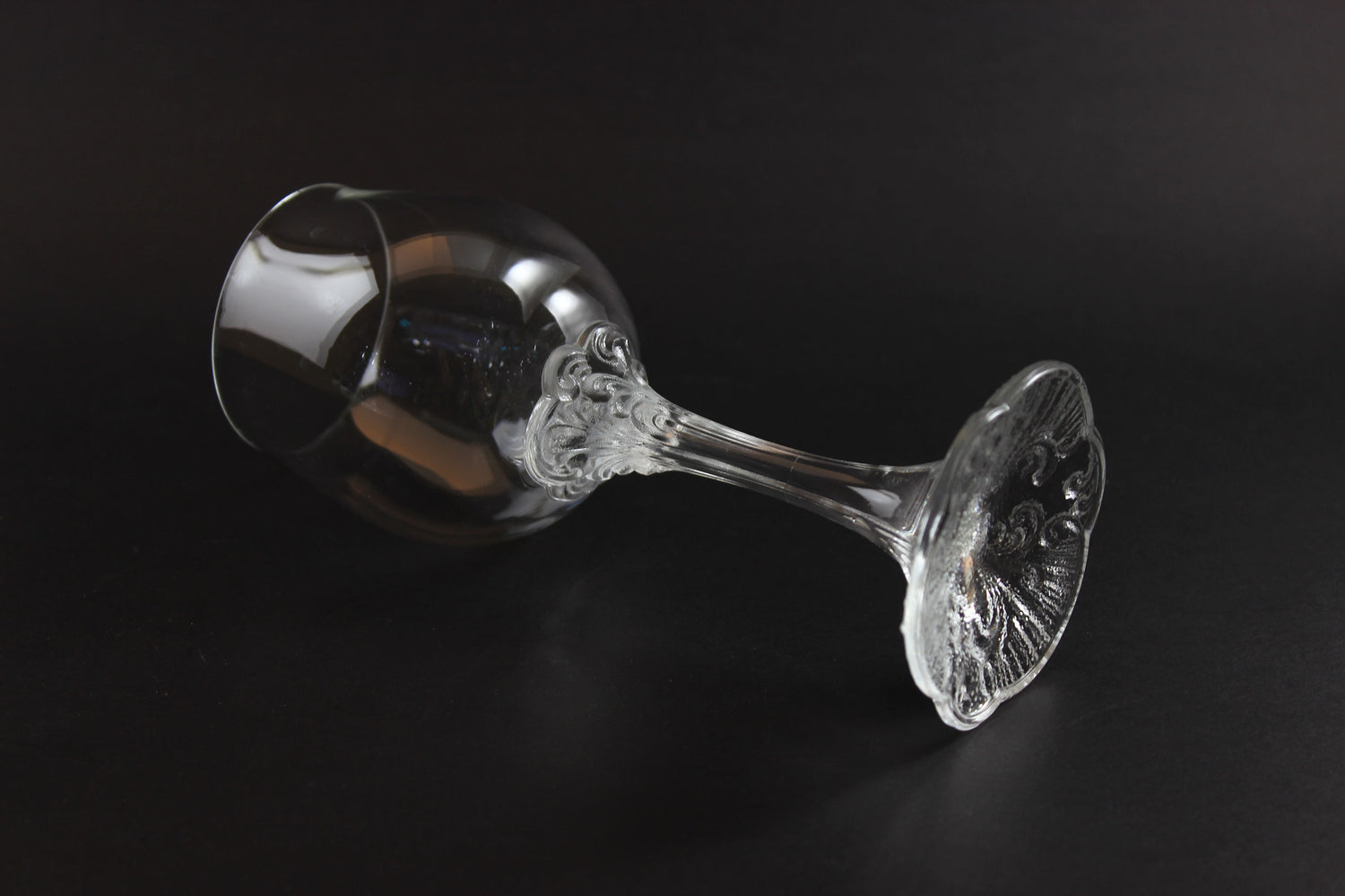Rosenthal wine glass with intricate design on a black background