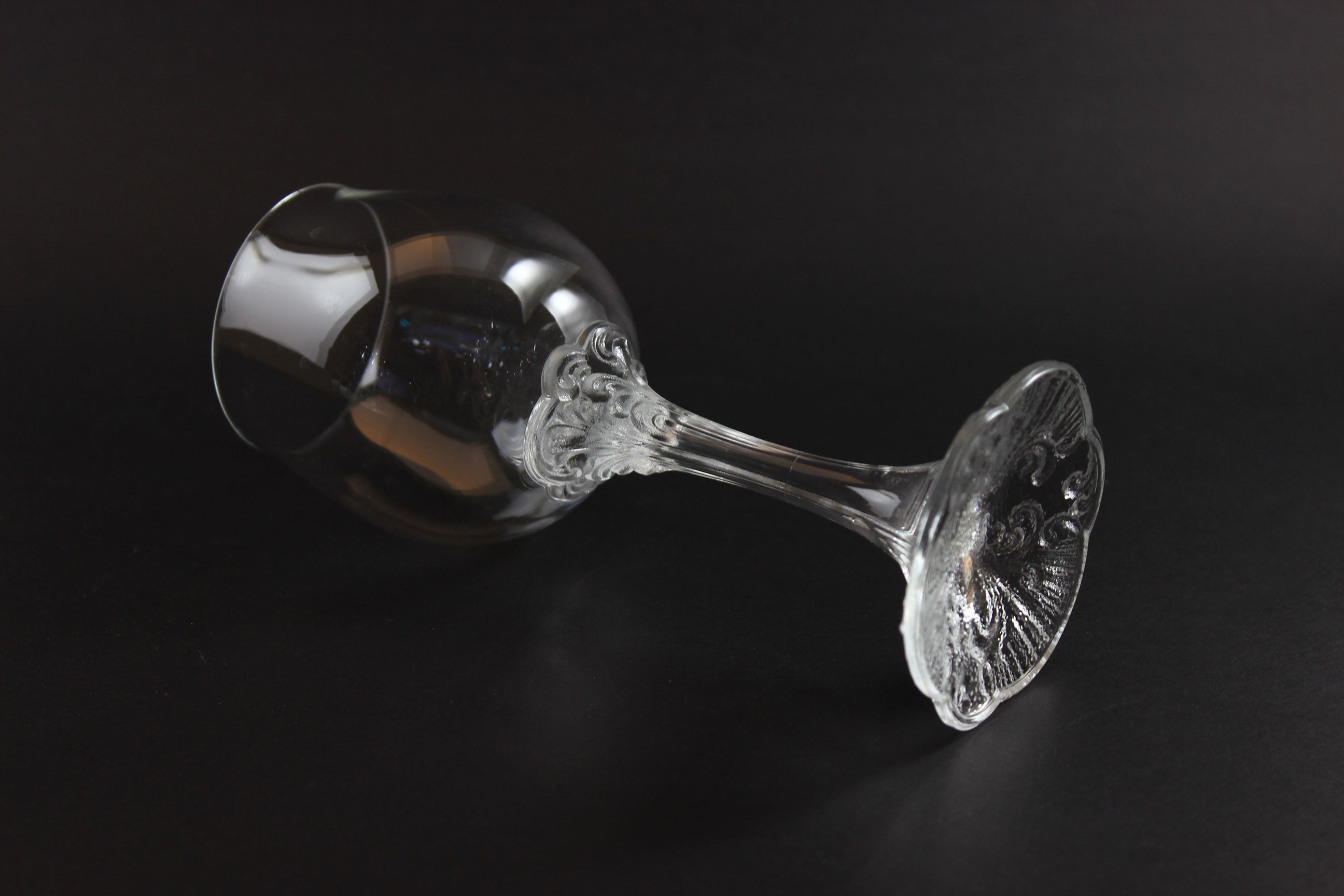 Rosenthal wine glass with intricate design on a black background