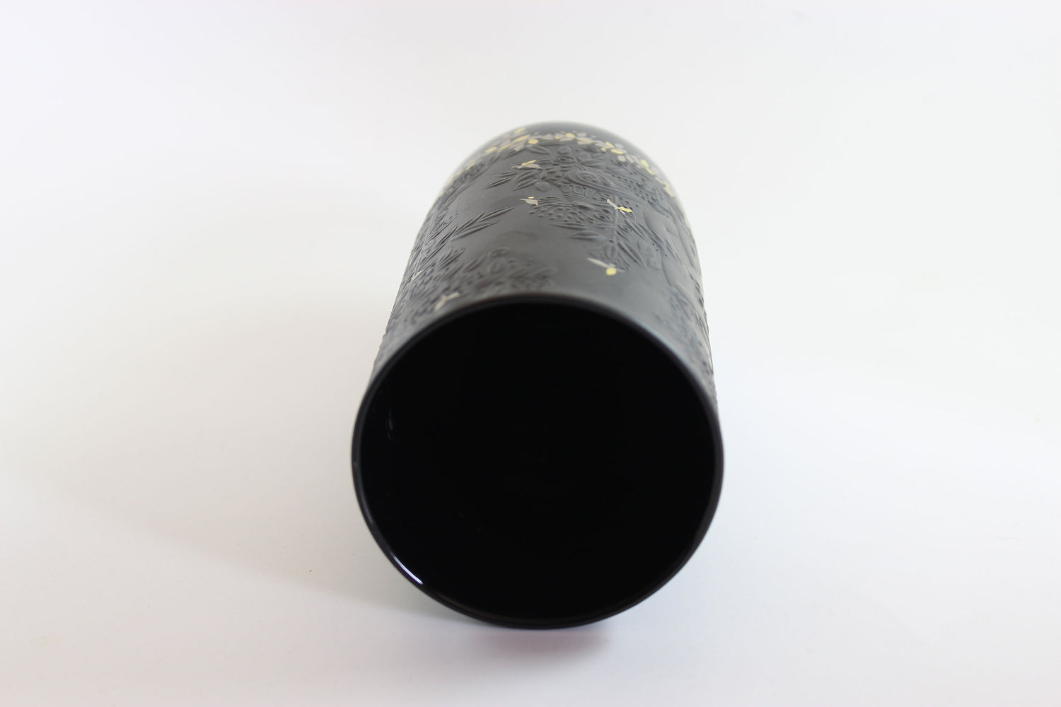Black cylindrical object on a white background