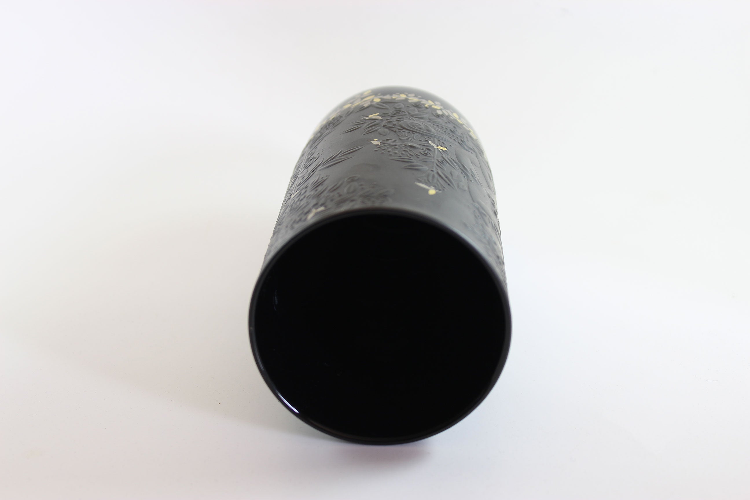 Black cylindrical object on a white background