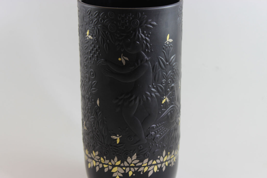Black vase with gold floral patterns on a white background