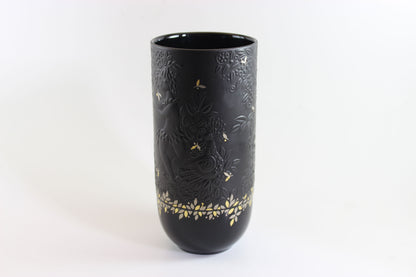 Black vase with gold embossed design on a white background