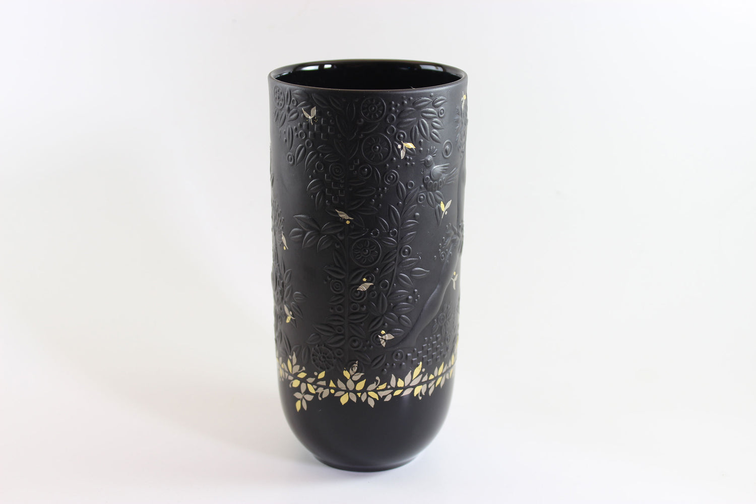Black vase with gold floral patterns on a white background