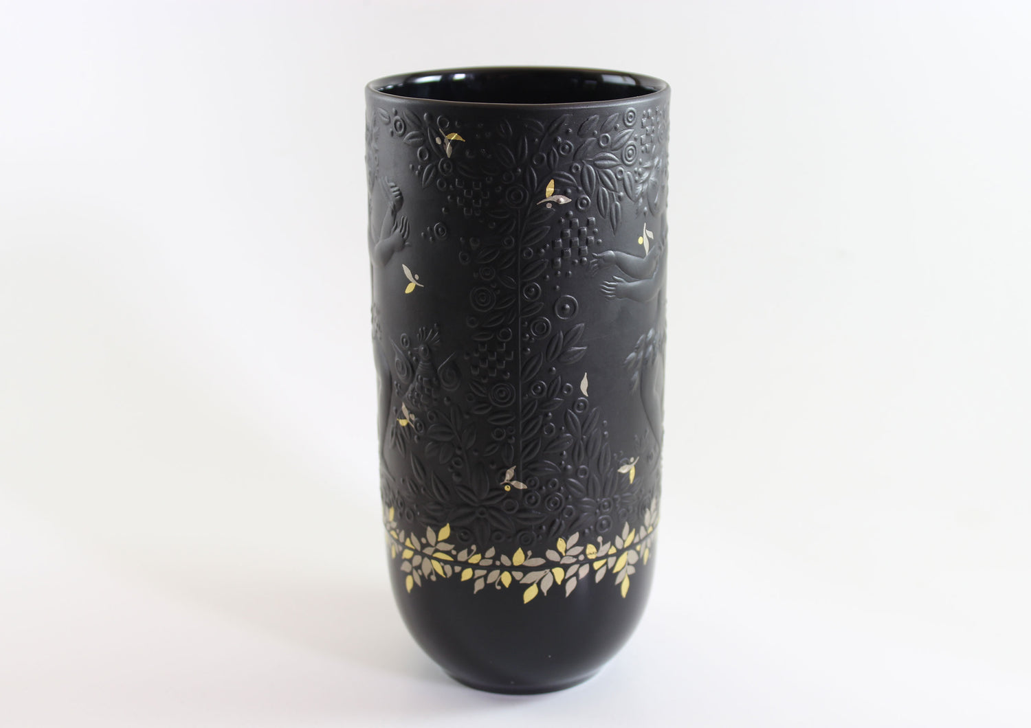 Black vase with gold embossed patterns on a white background