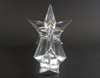Set of crystal star-shaped candleholders on a dark background