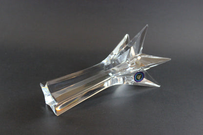 Set of crystal star-shaped candleholders on a dark background