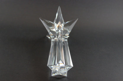 Set of crystal star-shaped candleholders on a dark background