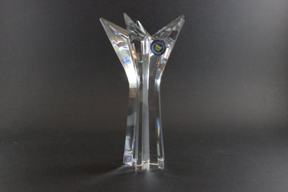 Set of crystal star-shaped candleholders on a dark background