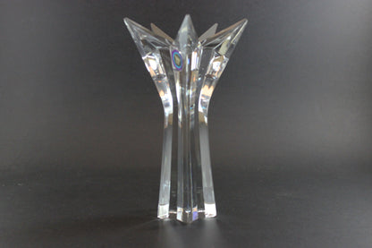 Set of crystal star-shaped candleholders on a dark background