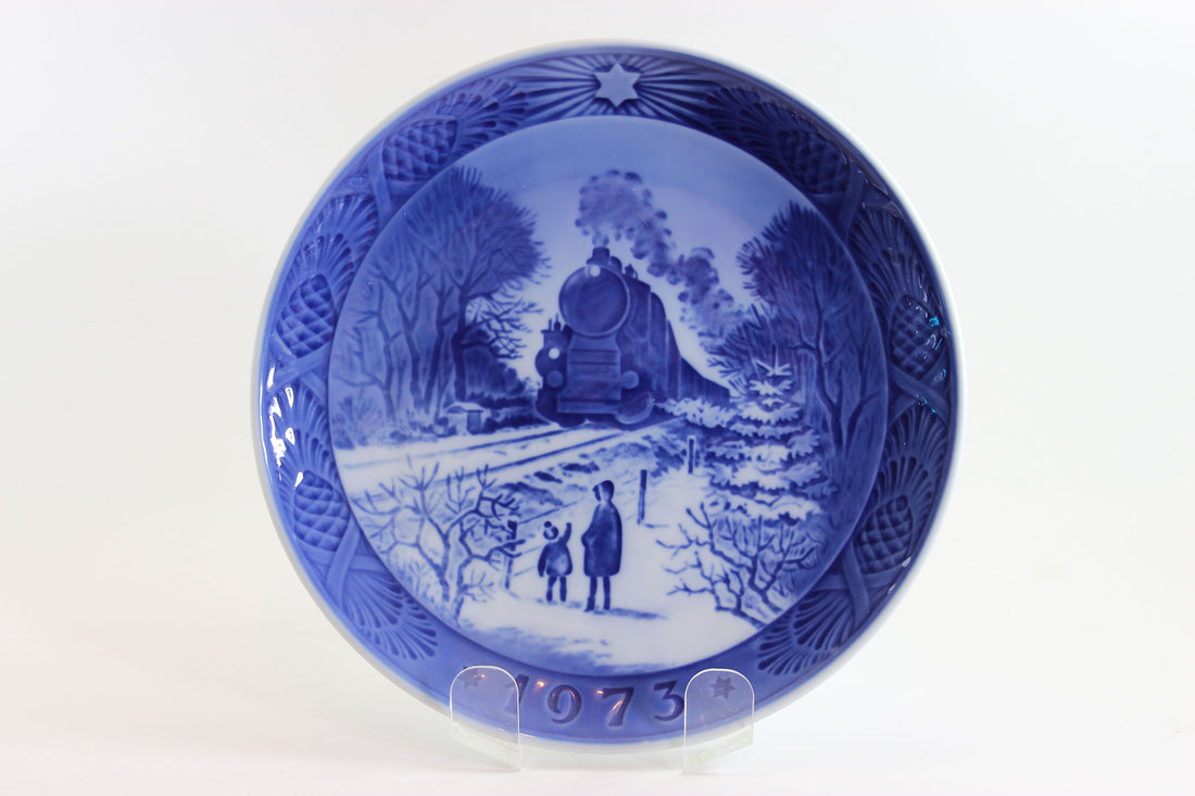 Blue and white ceramic plate with a scenic design and year &
