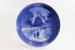 Blue and white ceramic plate with a scenic design and year &