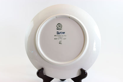 1974 Royal Copenhagen Blue ceramic plate with winter scene and owl, on a white background.