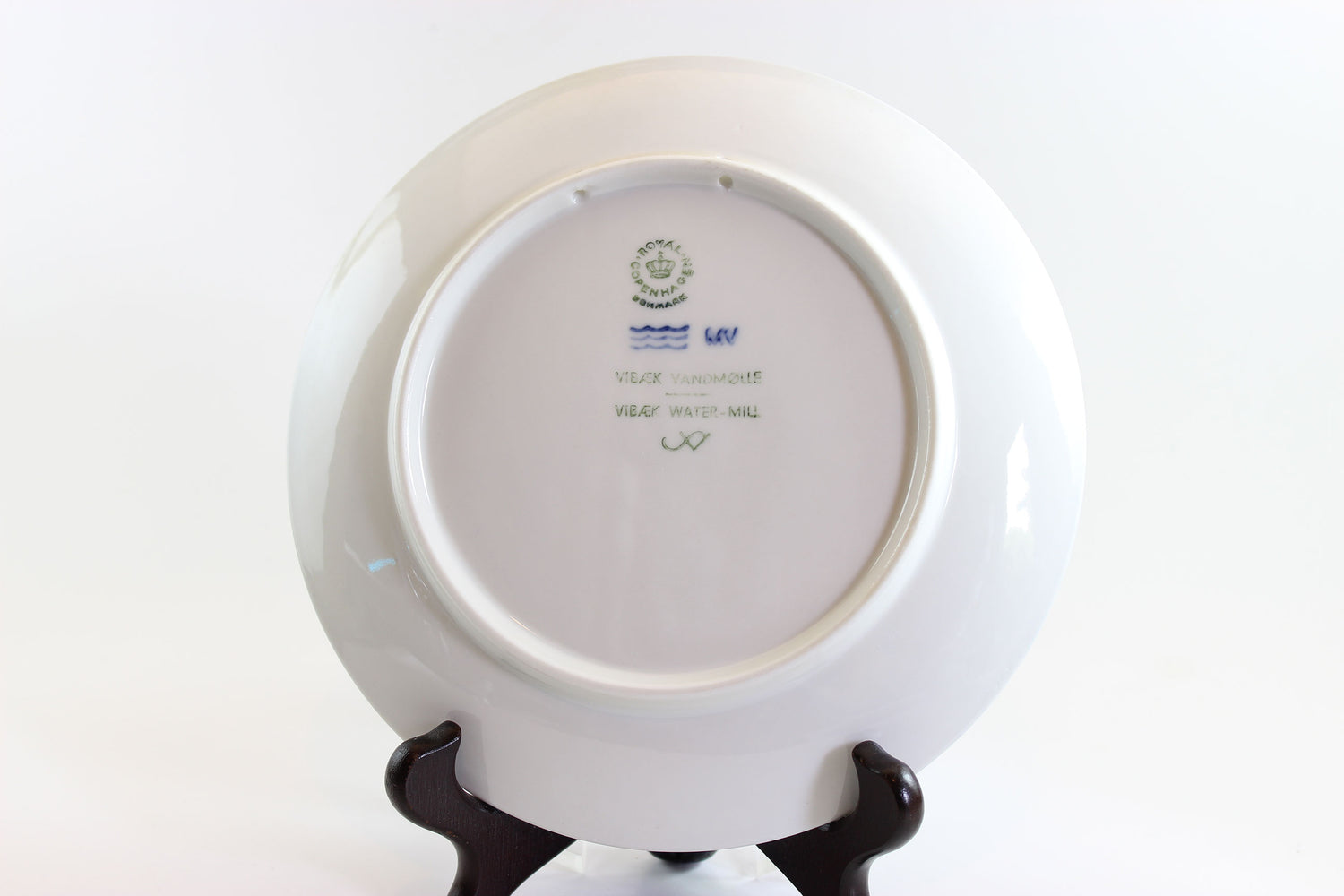 White plate with a visible brand logo on a white background