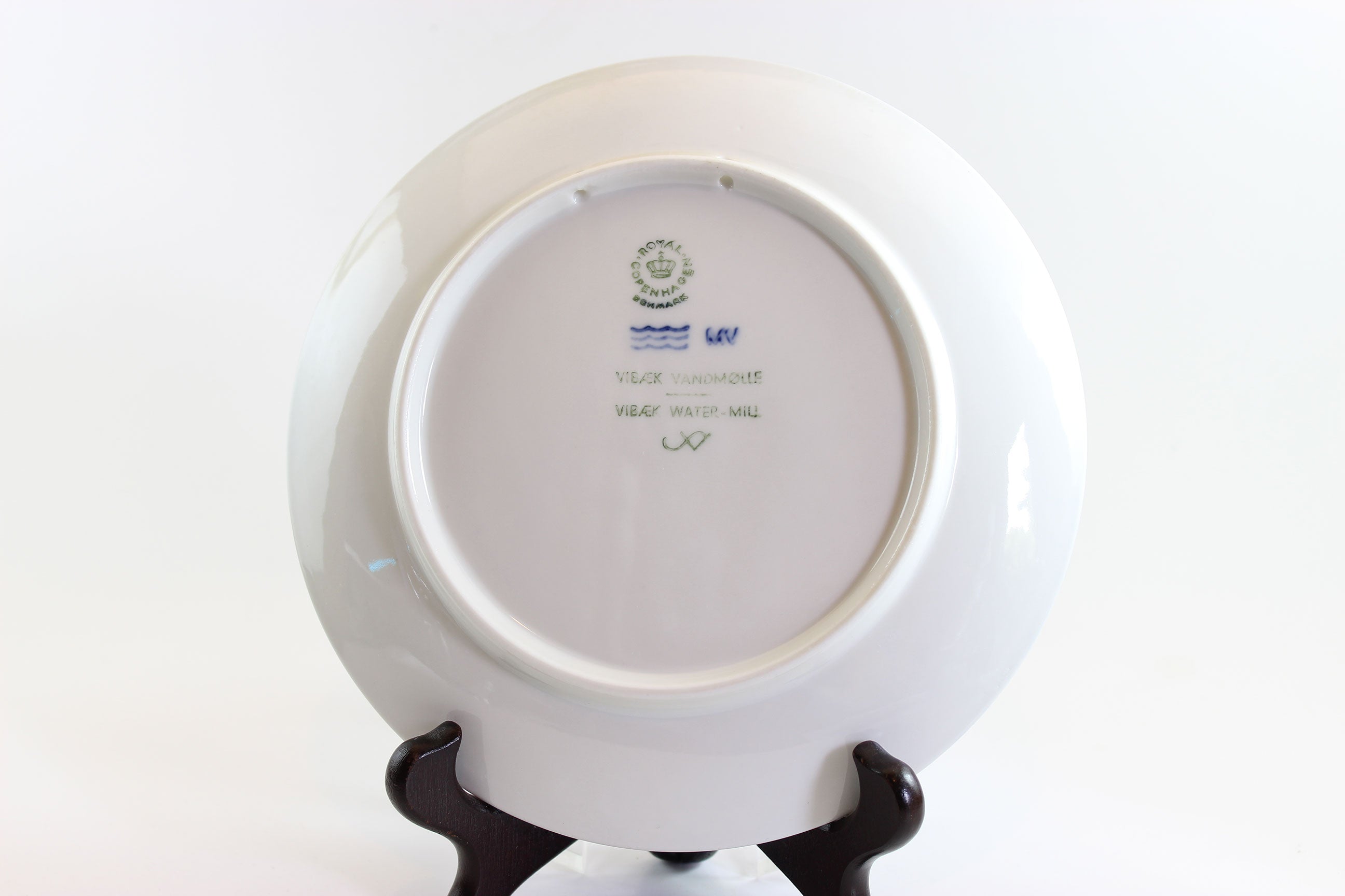 White plate with a visible brand logo on a white background