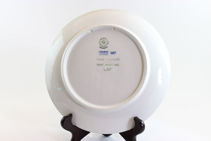 White plate with a visible brand logo on a white background