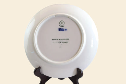 White ceramic plate with a stand on a white background