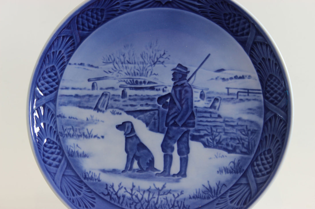Hunter with rifle and dog in winter at Immervad Bridge.