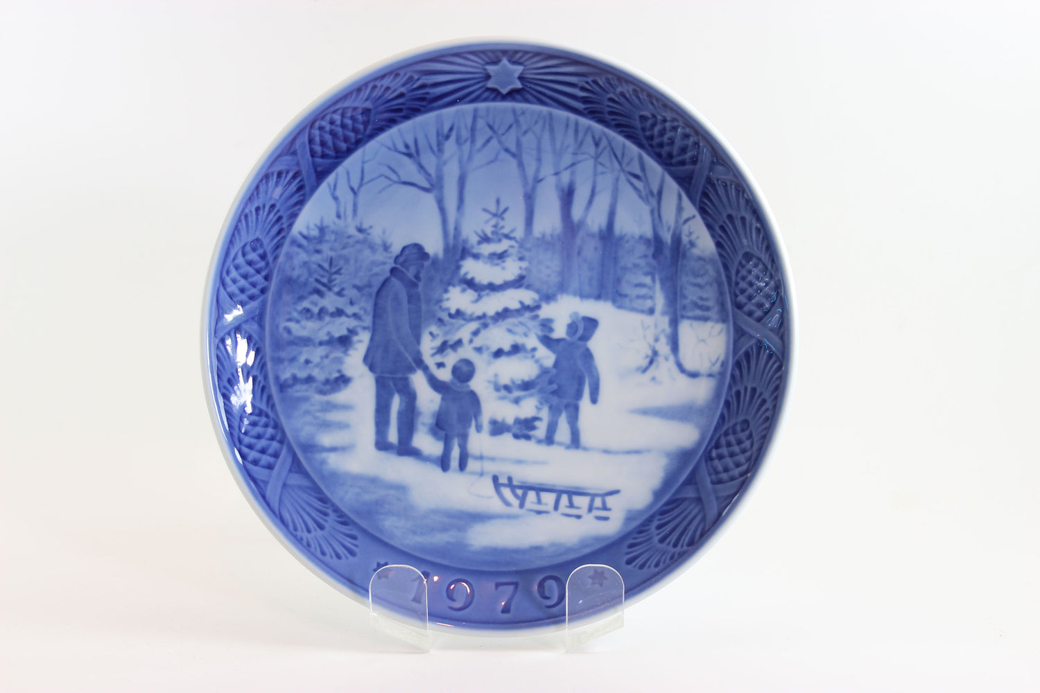 Blue and white decorative plate with winter scene and &