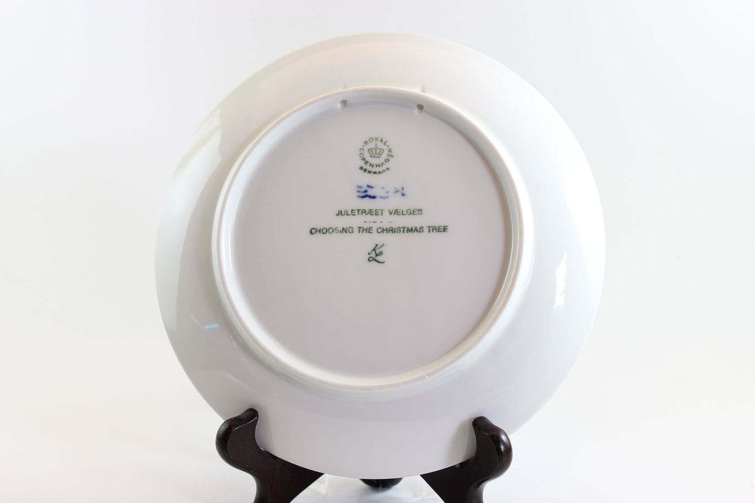 White ceramic plate with a stand on a white background