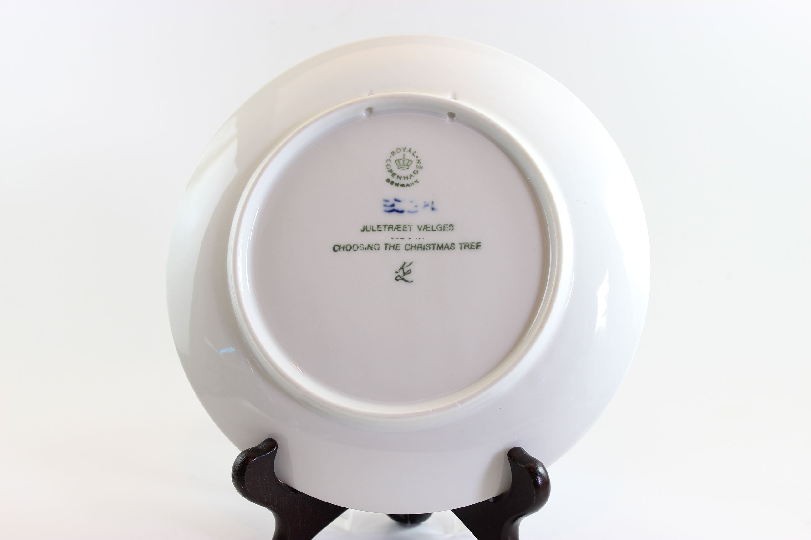 White ceramic plate with a stand on a white background