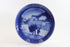 Annual blue and white Christmas plate 1980 with a scene of a man and child walking, on a white background.