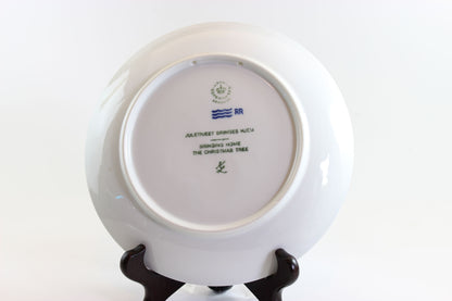 Annual blue and white Christmas plate 1980 with a scene of a man and child walking, on a white background.